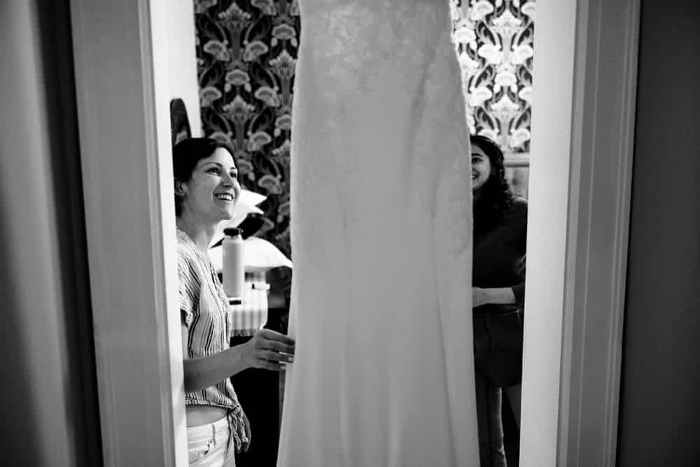 Bride looking at wedding dress while getting ready at Naples Hotel