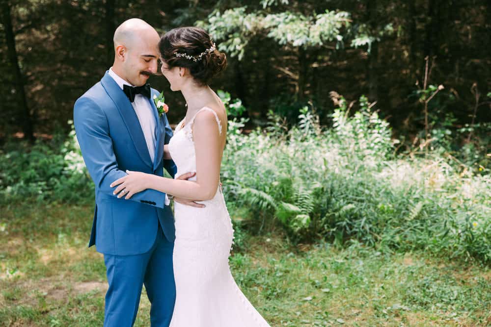 bride and groom portrait with wooded background in Naples, NY