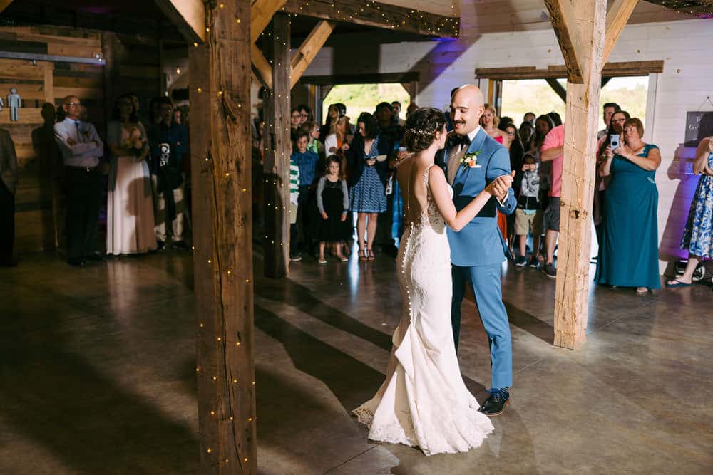 groom smiles at bride during first dance at Wren's Roost wedding reception