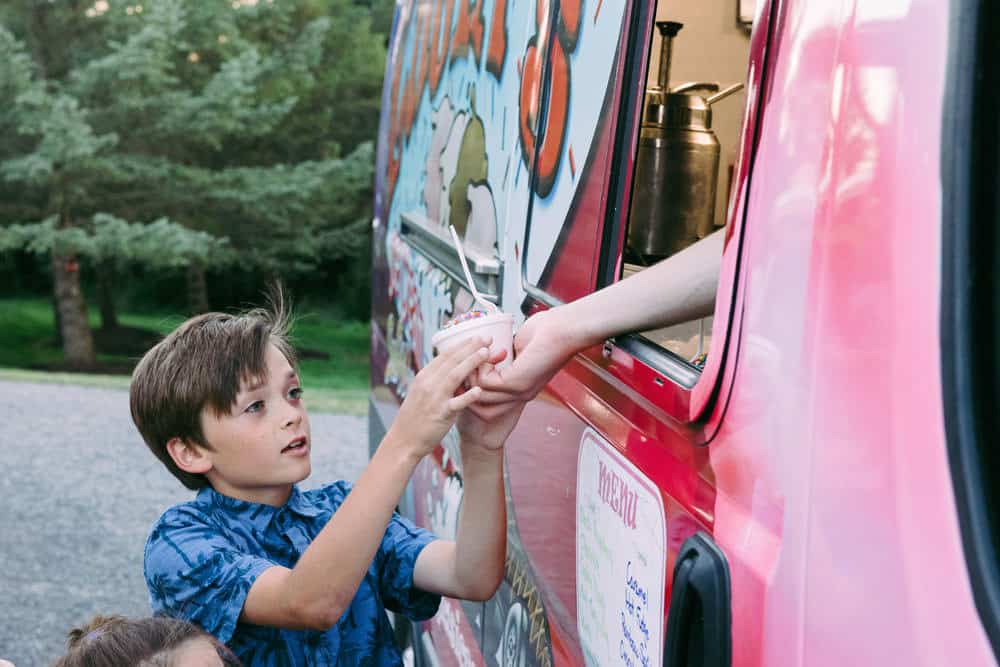 boy getting ice cream from Lugia's Ice Cream truck at wedding reception