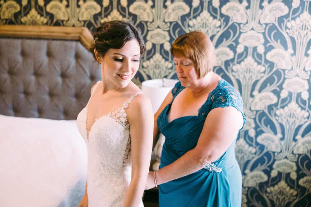 mother of bride helping with wedding dress at Naples Hotel